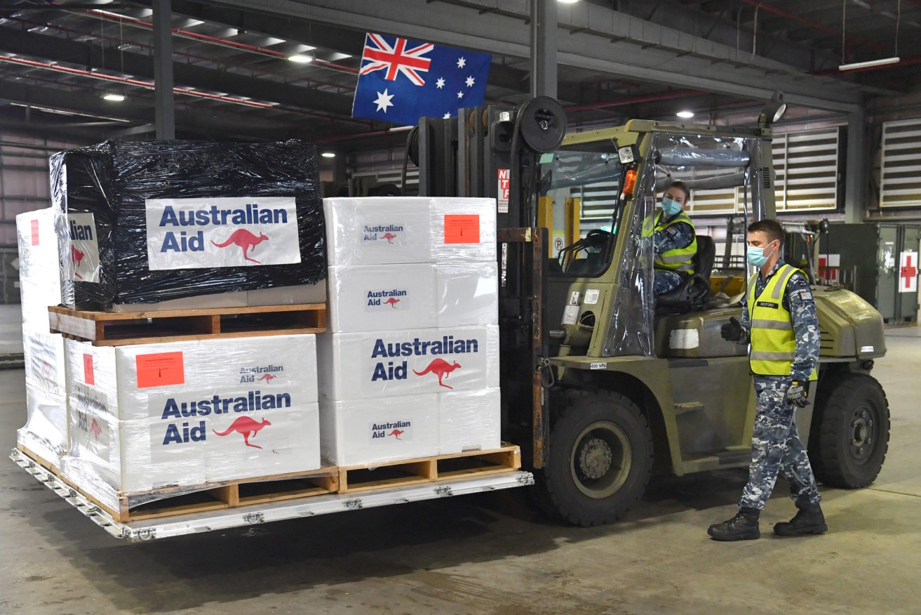 Royal Australian Air Force personal are seen preparing COVID-19 vaccines and humanitarian supplies for loading onto a C-17A Globemaster at RAAF Base Amberley, west of Brisbane, Tuesday, March 23, 2021. Australia are sending 8,000 doses of its COVID-19 vaccine supply to Papua New Guinea who have more than 1,400 active cases of COVID-19 and the Australian government are asking AstraZeneca and European authorities to divert another 1 million doses to Papua New Guinea. (AAP Image/Darren England) NO ARCHIVING