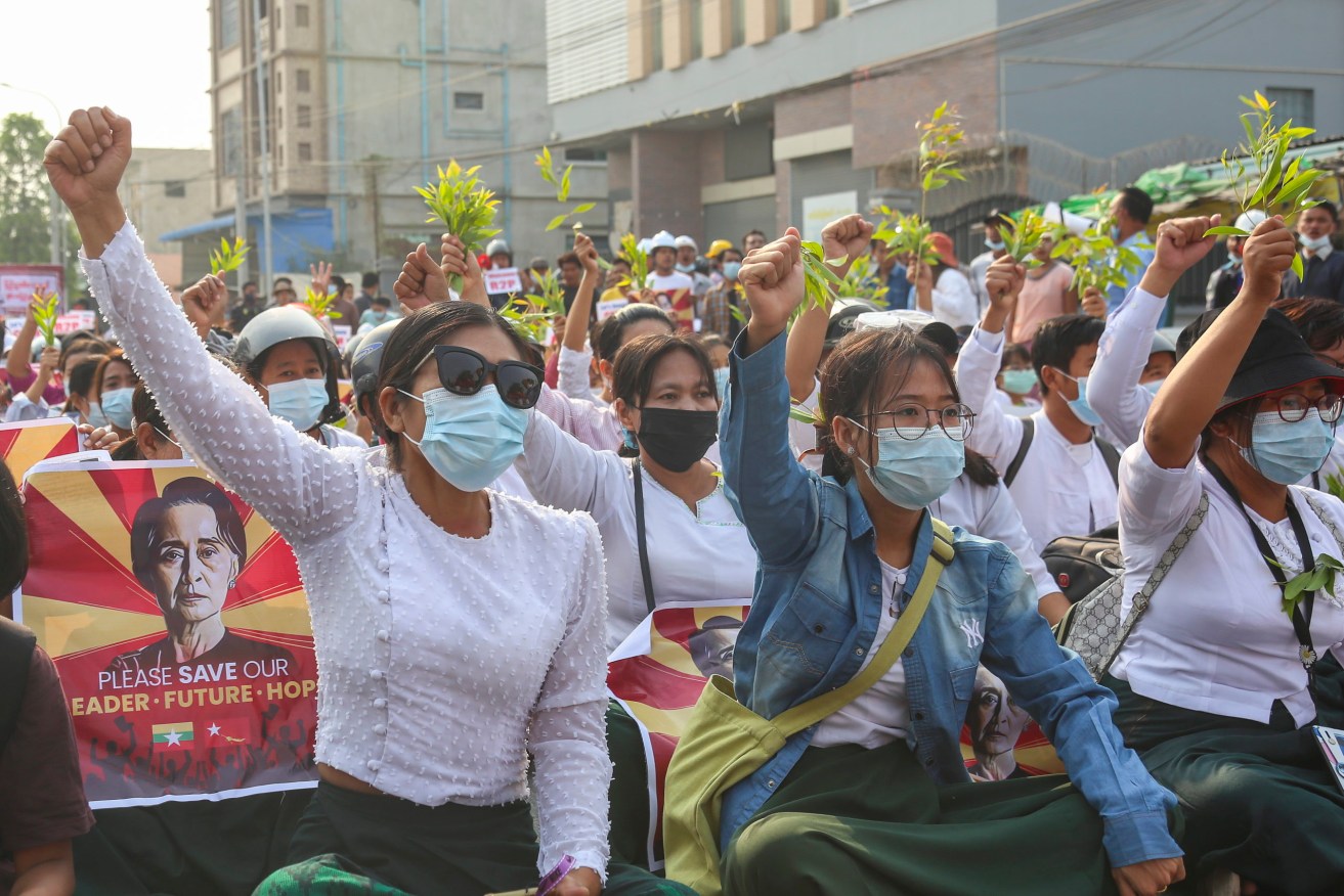 Demonstrators shout slogans during a protest against the military coup in Mandalay, Myanmar. An Australian couple has been freed from house arrest. (Photo: EPA/STR)