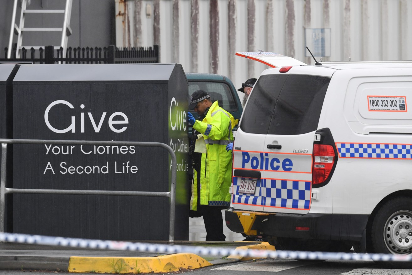 Police establish a crime scene after the body of a woman was found inside a charity bin at a Stockland shopping centre at Burleigh Heads. (AAP Image/Darren England) 