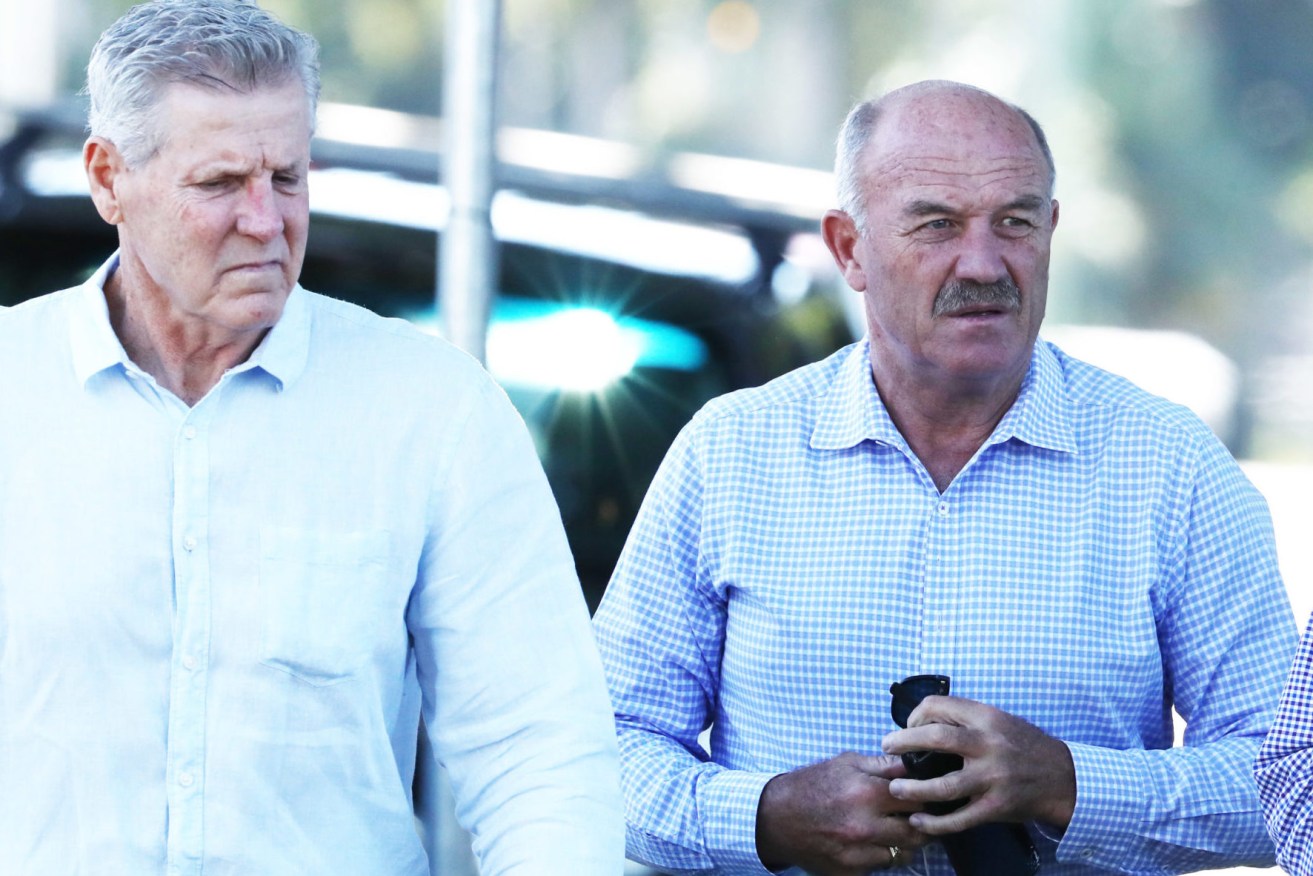 Queensland greats Gene Miles (left) and Wally Lewis attend the funeral for State of Origin rival Tommy Raudonikis at Sacred Heart Catholic Church on the Gold Coast. (AAP Image/Jason O'Brien) 