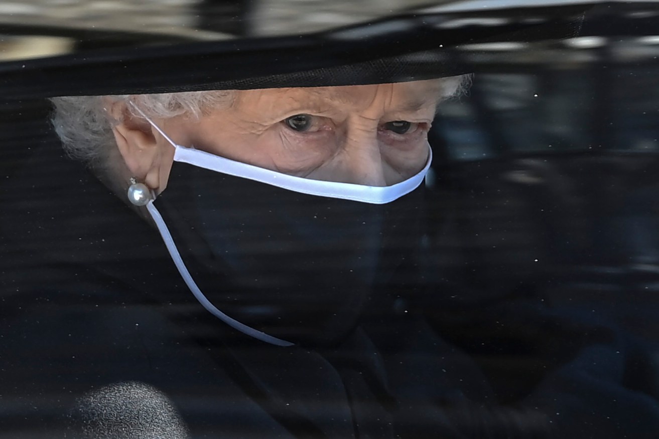 Britain's Queen Elizabeth II follows the coffin in a car as it makes it's way past the Round Tower during the funeral of Britain's Prince Philip inside Windsor Castle in Windsor. (Leon Neal/Pool via AP)