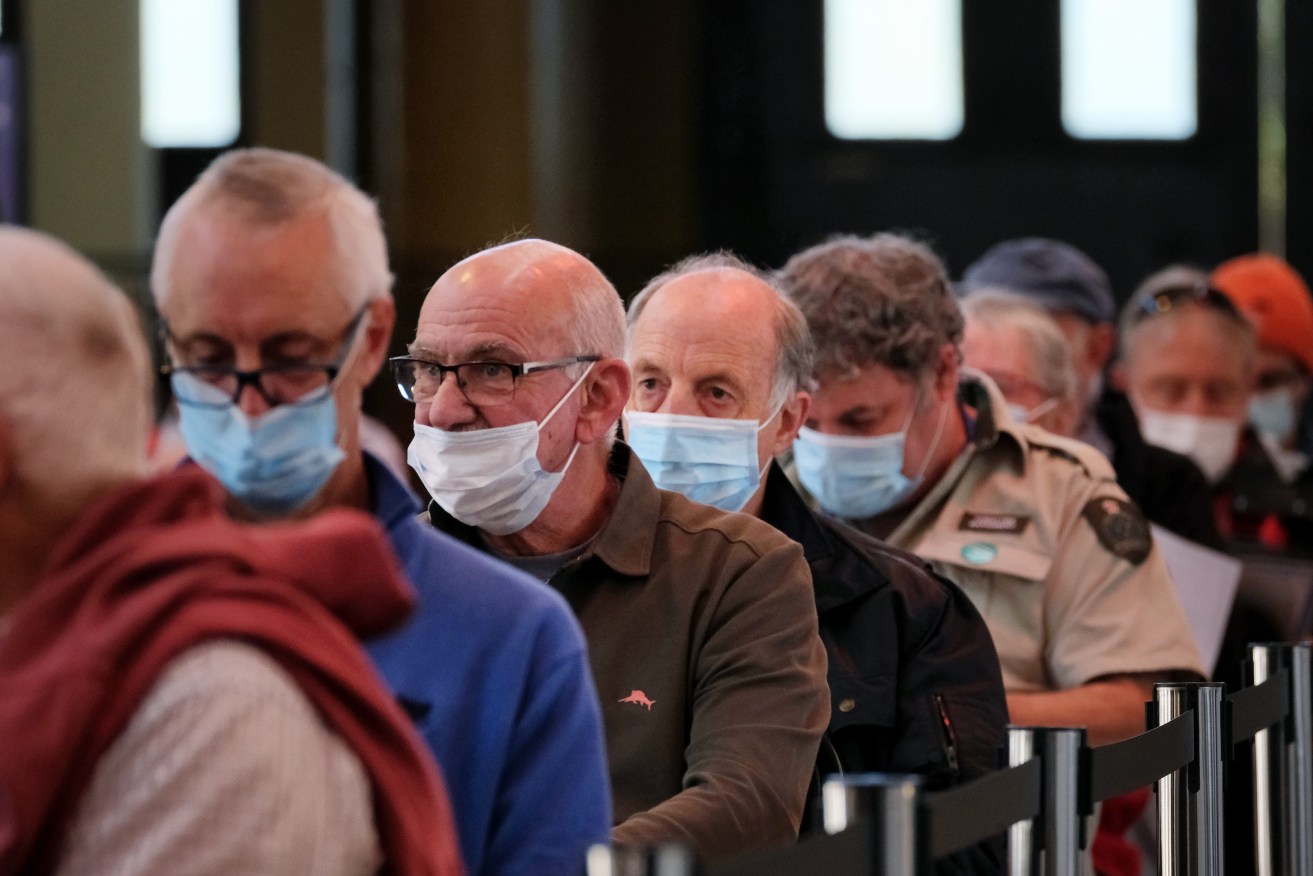 People attend the mass vaccination hub at the Royal Exhibition Building in Melbourne. Those over 70 can show up at three Victorian mass COVID-19 vaccination hubs without an appointment from Wednesday. (AAP Image/Luis Ascui)