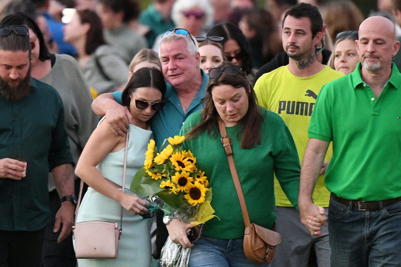 The family of Kelly Wilkinson depart a vigil for murdered mother on the Gold Coast,.  . (AAP Image/Dave Hunt) 