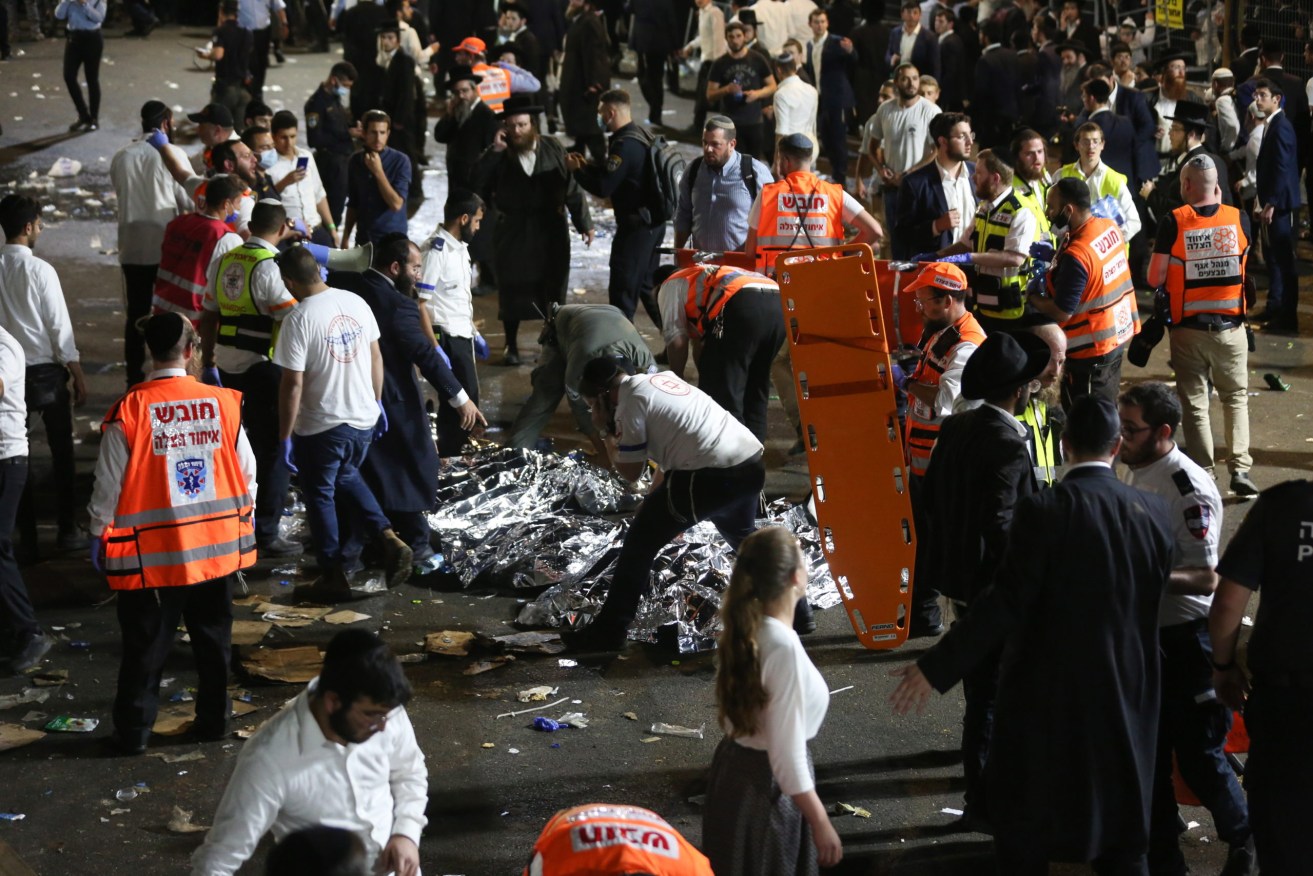 Israeli security officials and rescuers inspect the dead bodies of dozens of Ultra-Orthodox Jews who died during an event at a revelry complex during Lag Ba'Omer in Mount Meron, Israel.  Photo: EPA/David Cohen