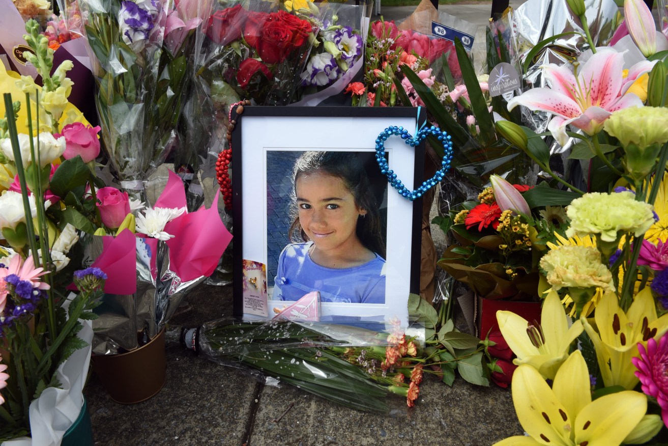 A floral tribute to Tia Palmer at the gates of Marsden State High School in 2015. Photo: AAP Image/Dan Peled