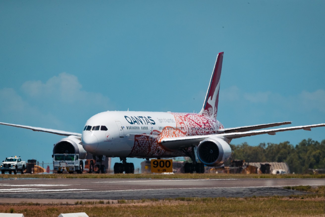 A Qantas charter plane carrying repatriated Australians at Darwin Airport. (AAP Image/Charlie Bliss)