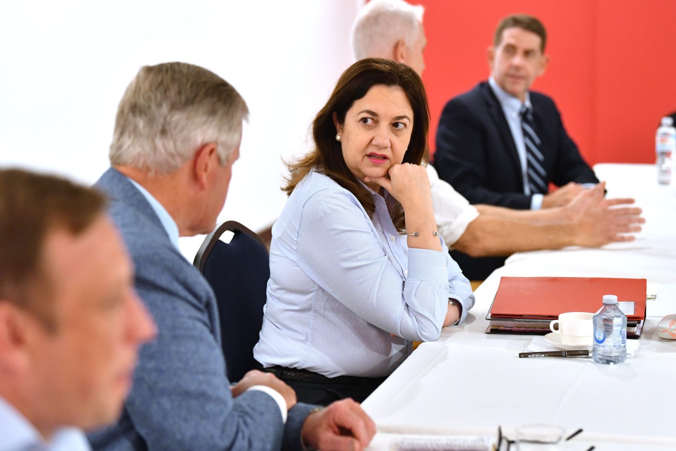 Queensland Premier Annastacia Palaszczuk (centre) and Treasurer Cameron Dick (rear) during a Cabinet meeting at the Qantas Founders Museum in Longreach. (AAP Image/Darren England)