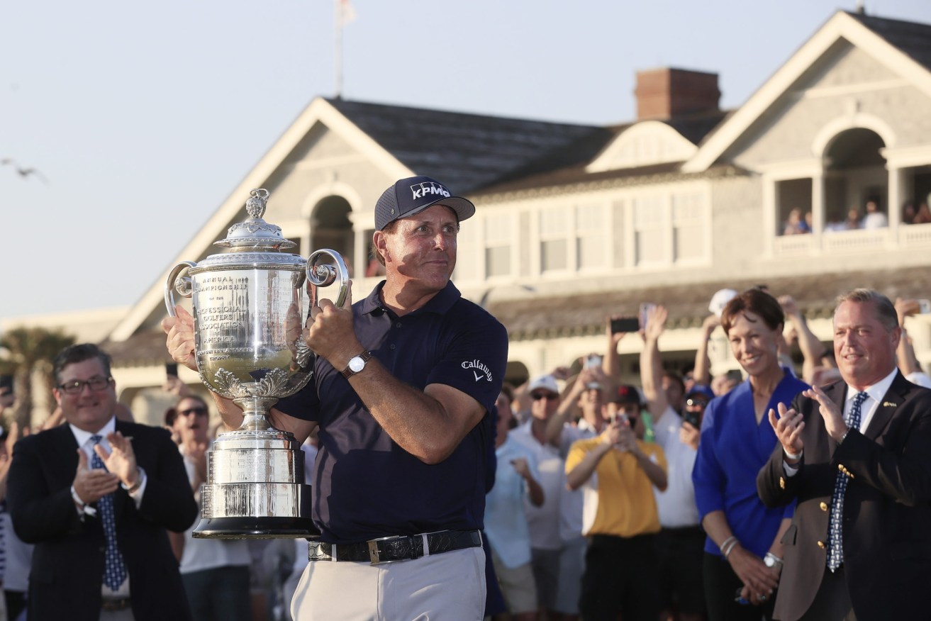 epa09224477 Phil Mickelson of the US hoists the Wannamaker Trophy after winning the 2021 PGA Championship golf tournament on the Ocean Course at Kiawah Island, South Carolina, USA, 23 May 2021. The PGA Championship runs from 20 May through 23 May.  EPA/TANNEN MAURY