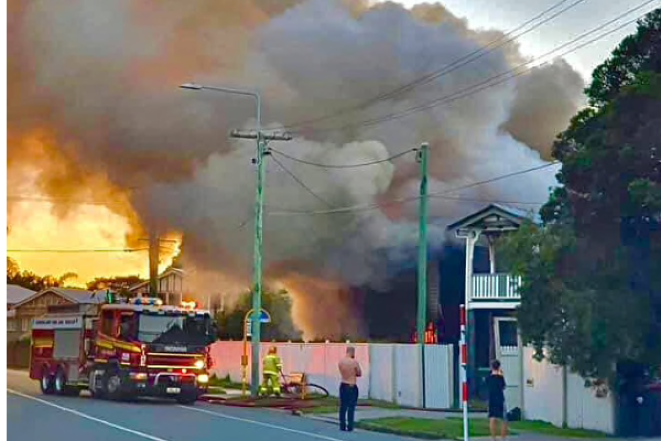 Flames engulfed the Everleigh Street, Wooloowin home on Sunday, . (Supplied: Queensland Ambulance Service)