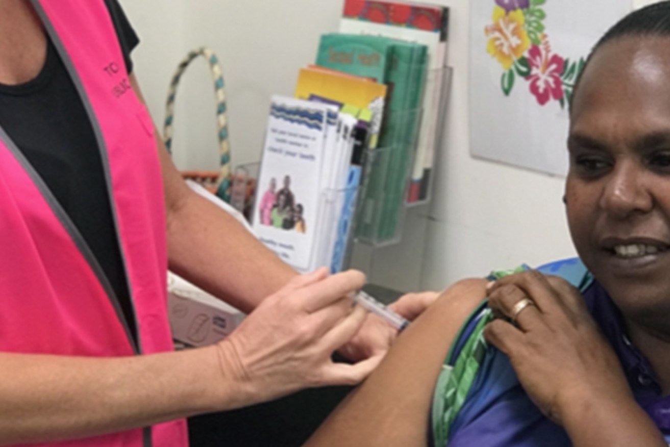 Nurse Immuniser Ruth Ferguson vaccinates Saibai Island school teacher Norah Tabuai in the early phase of the AstraZeneca rollout. (Image: Queensland Health)