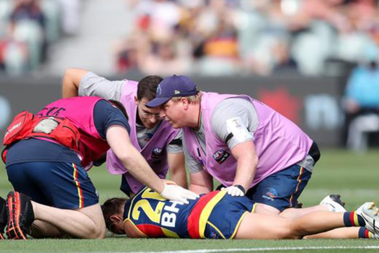 Adelaide Crows skipper Chelsea Randall is treated for a heavy head knock during last the the AFLW preliminary final.(AAP: Matt Turner)