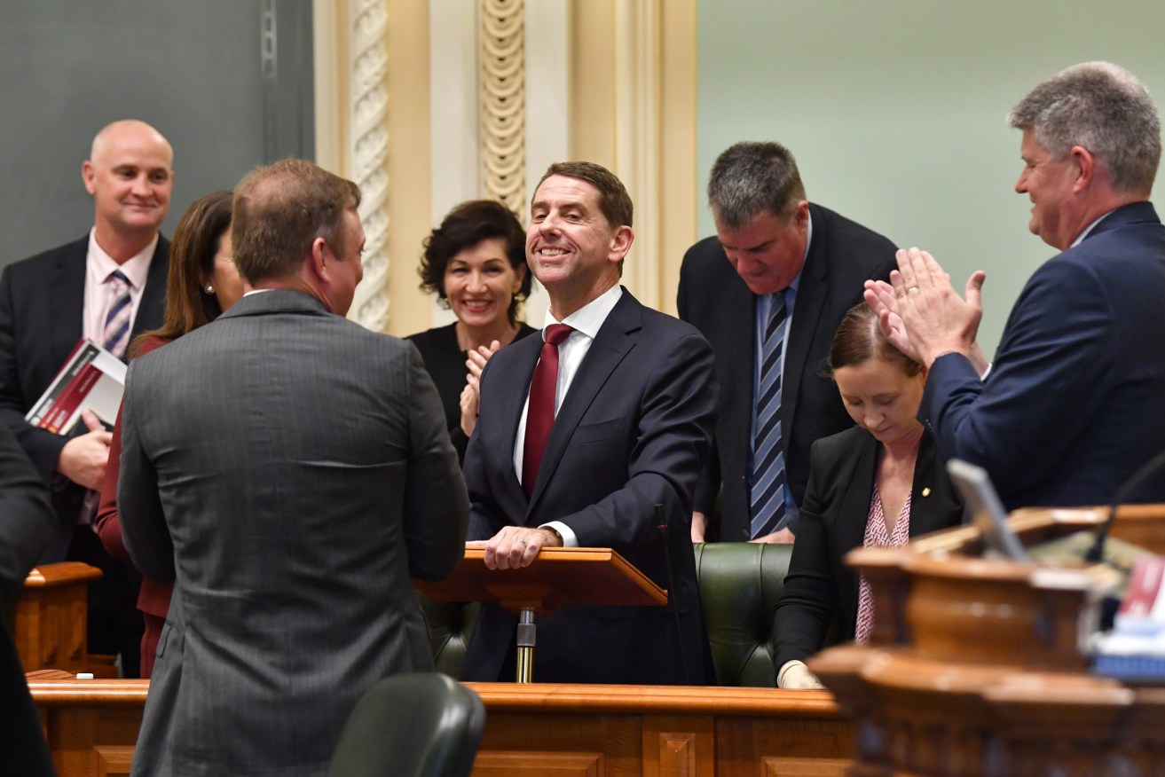 Queensland Treasurer Cameron Dick (centre) is seen being congratulated by colleagues after the handing down the 2021/22 Queensland state budget at Queensland Parliament House. (AAP Image/Darren England) 