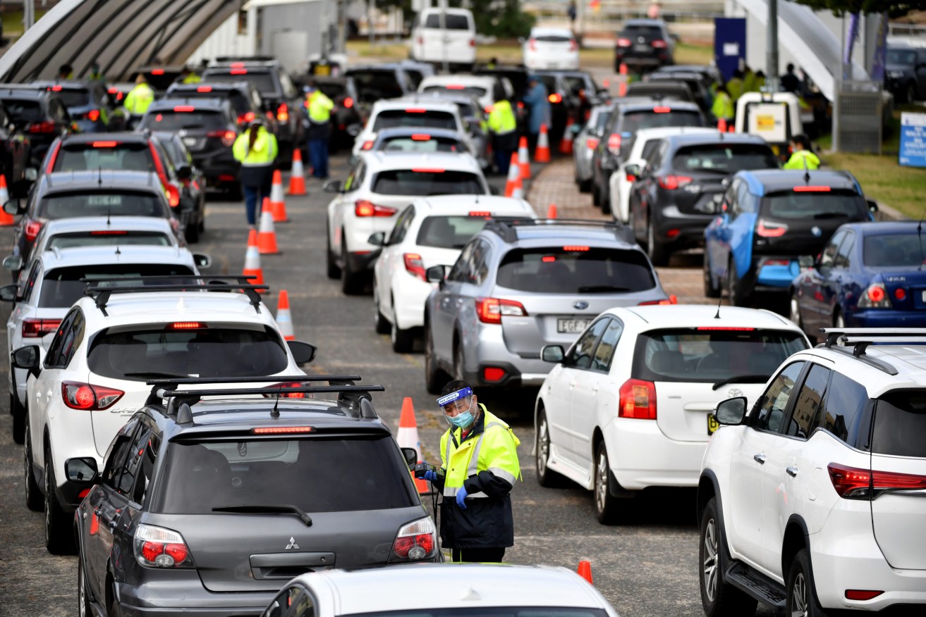 Cars line up for Covid-19 testing at Bondi in Sydney, on Tuesday as the NSW eastern suburbs cluster continues to grow. Queensland has locked out residents from several Sydney local council areas.  (AAP Image/Joel Carrett)
