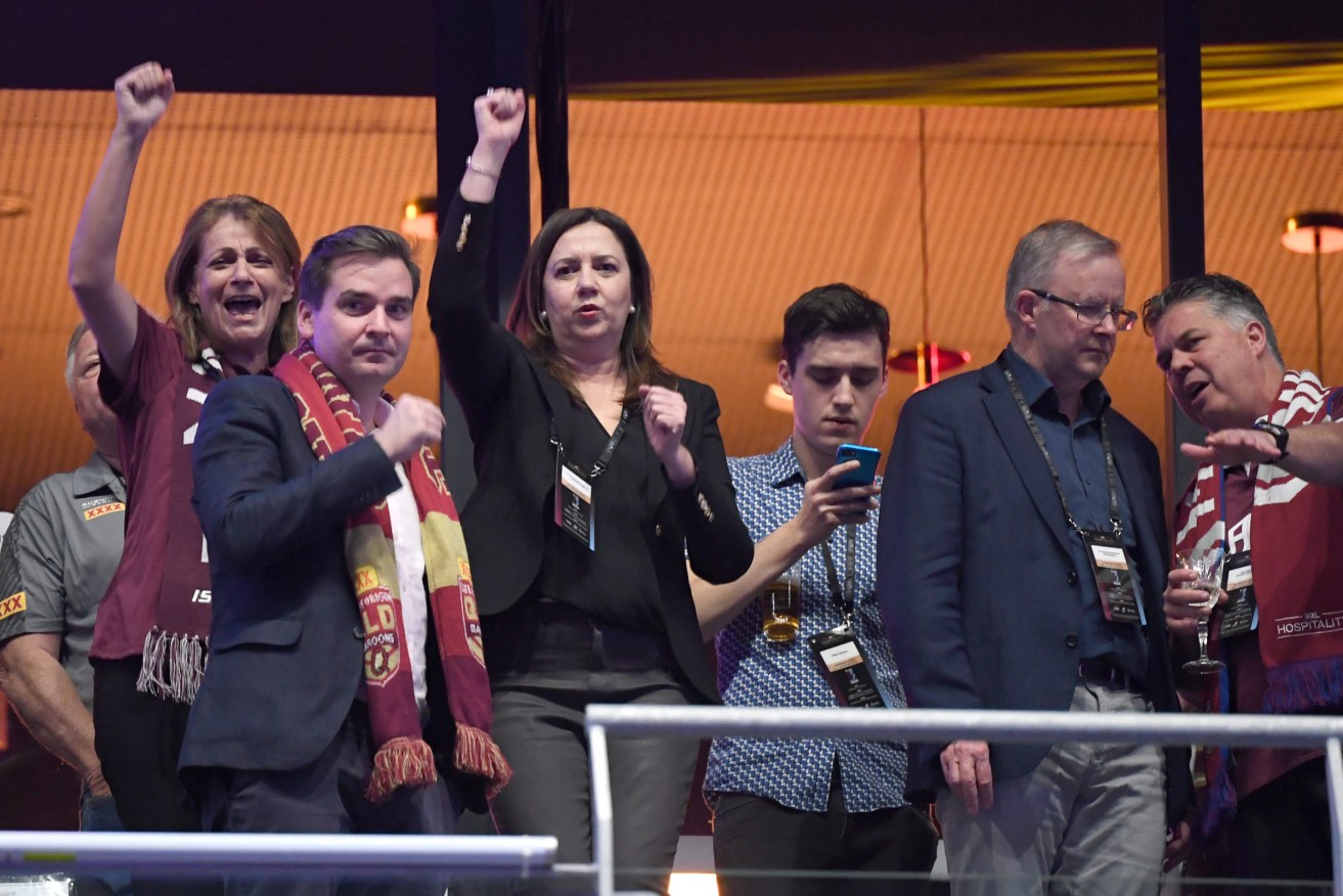 Queensland Premier Annastacia Palaszczuk (centre) is seen dancing as Federal Opposition leader Anthony Albanese (2nd from right) looks on during game one of the 2021 State of Origin series between the New South Wales Blues and the Queensland Maroons at Queensland Country Bank Stadium in Townsville. (AAP Image/Darren England) 