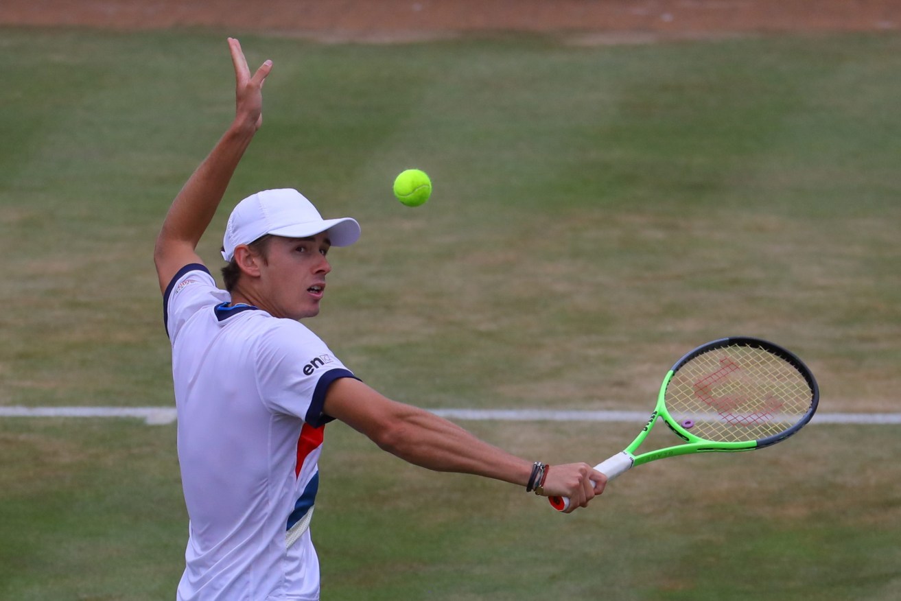 Australia's Alex de Minaur, pictured in action at the Queen's Club in London, has tested positive to coronavirus and is out of the Tokyo Olympics.  (Image: EPA/VICKIE FLORES)