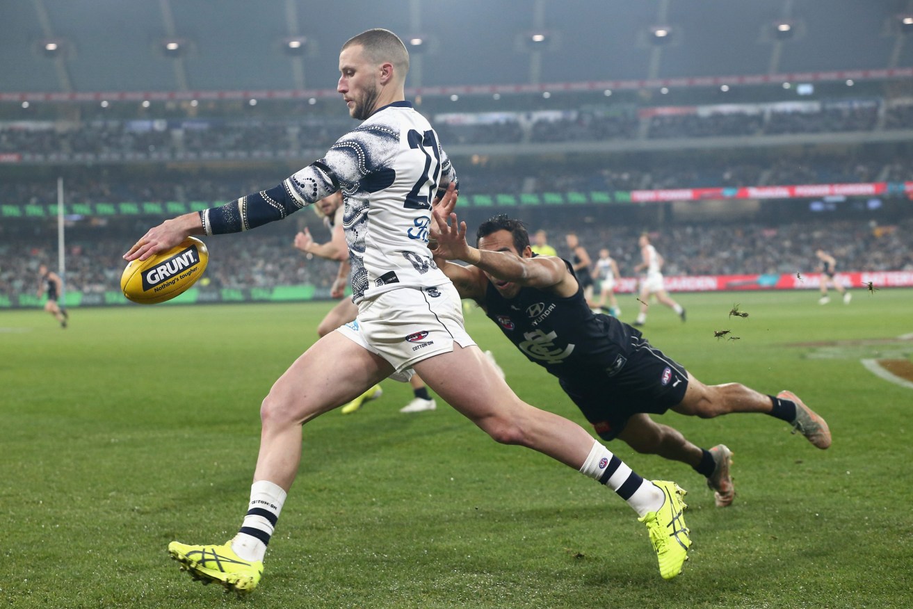 A sport-loving teacher, who acquired the coronavirus at an AFL match between Geelong and Carlton at the MCG, is now believed responsible for a third of the current Victorian outbreak. (AAP Image/Rob Prezioso) 
