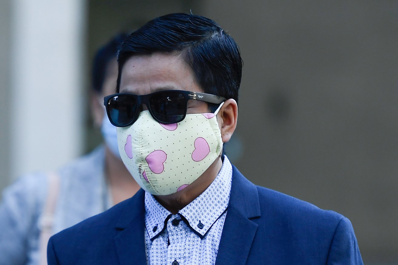 My Ut Trinh is seen departing the Brisbane District Court, in Brisbane, Tuesday. Trinh was cleared of all charges after being accused of putting needles in strawberries and sparking a national contamination scare in 2018. (AAP Image/Albert Perez) 