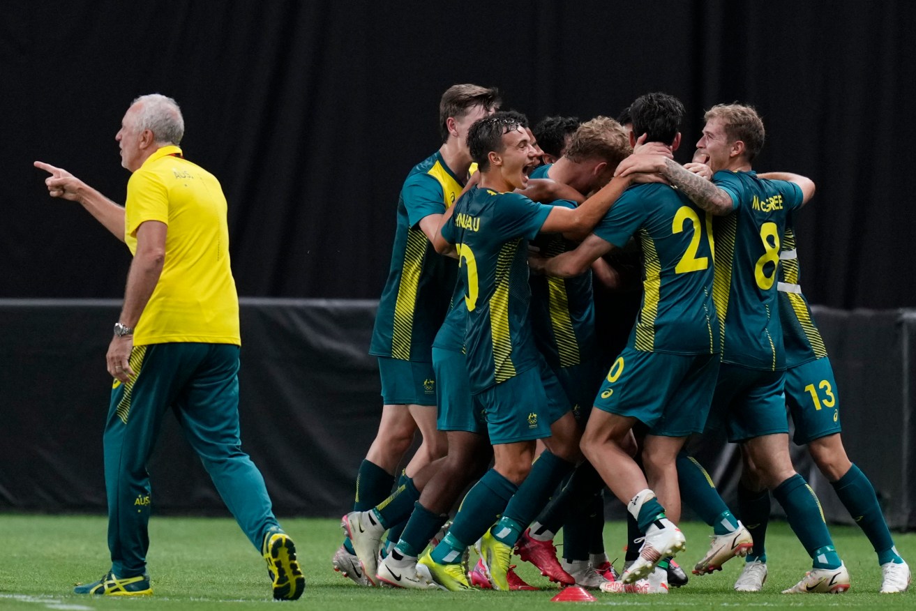 The Olyroos celebrate after Australia's Marco Tilio scored their side's second goal against Argentina during a men's soccer match at the 2020 Summer Olympics in Sapporo. (AP Photo/SIlvia Izquierdo)