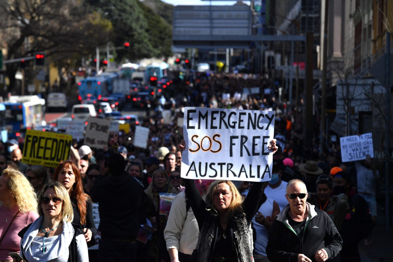 Protesters march along Broadway and George St towards Sydney Town Hall during the ‘World Wide Rally For Freedom’ anti-lockdown rally at Hyde Park in Sydney, Saturday. (AAP Image/Mick Tsikas) 