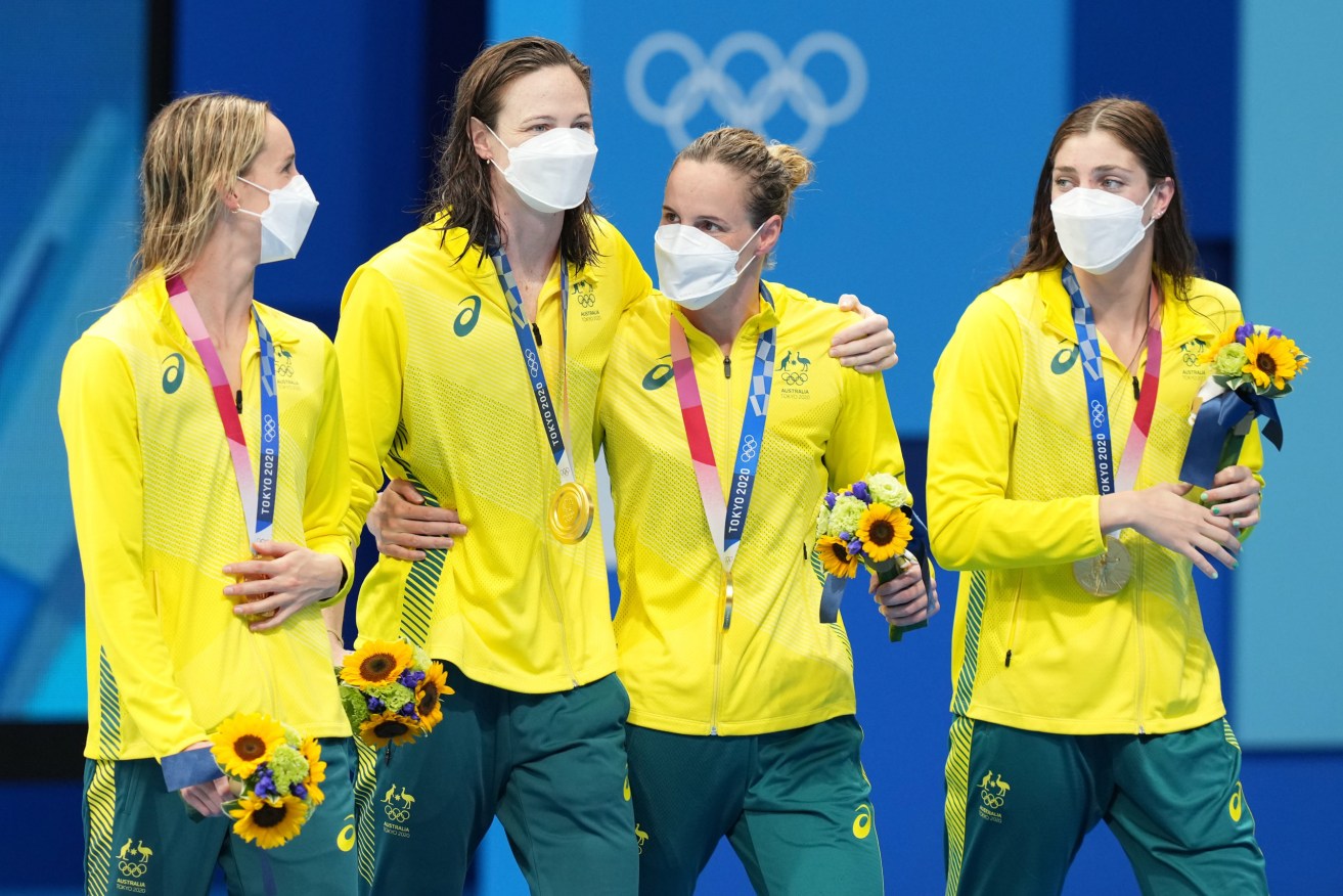 Australia’s 4 x 100m Women’s freestyle team (lt-rt) Emma McKeon, Cate Campbell, Bronte Campbell and Meg Harris with their Gold Medals after winning the Women's 4 x 100m Freestyle Relay final with a world record time at the Tokyo Aquatic Centre during the Tokyo Olympic Games, Sunday, July 25, 2021. (AAP Image/Joe Giddens) NO ARCHIVING, EDITORIAL USE ONLY, IMAGES TO BE USED FOR NEWS REPORTING PURPOSES ONLY, NO COMMERCIAL USE WHATSOEVER, NO USE IN BOOKS WITHOUT PRIOR WRITTEN CONSENT FROM AAP
