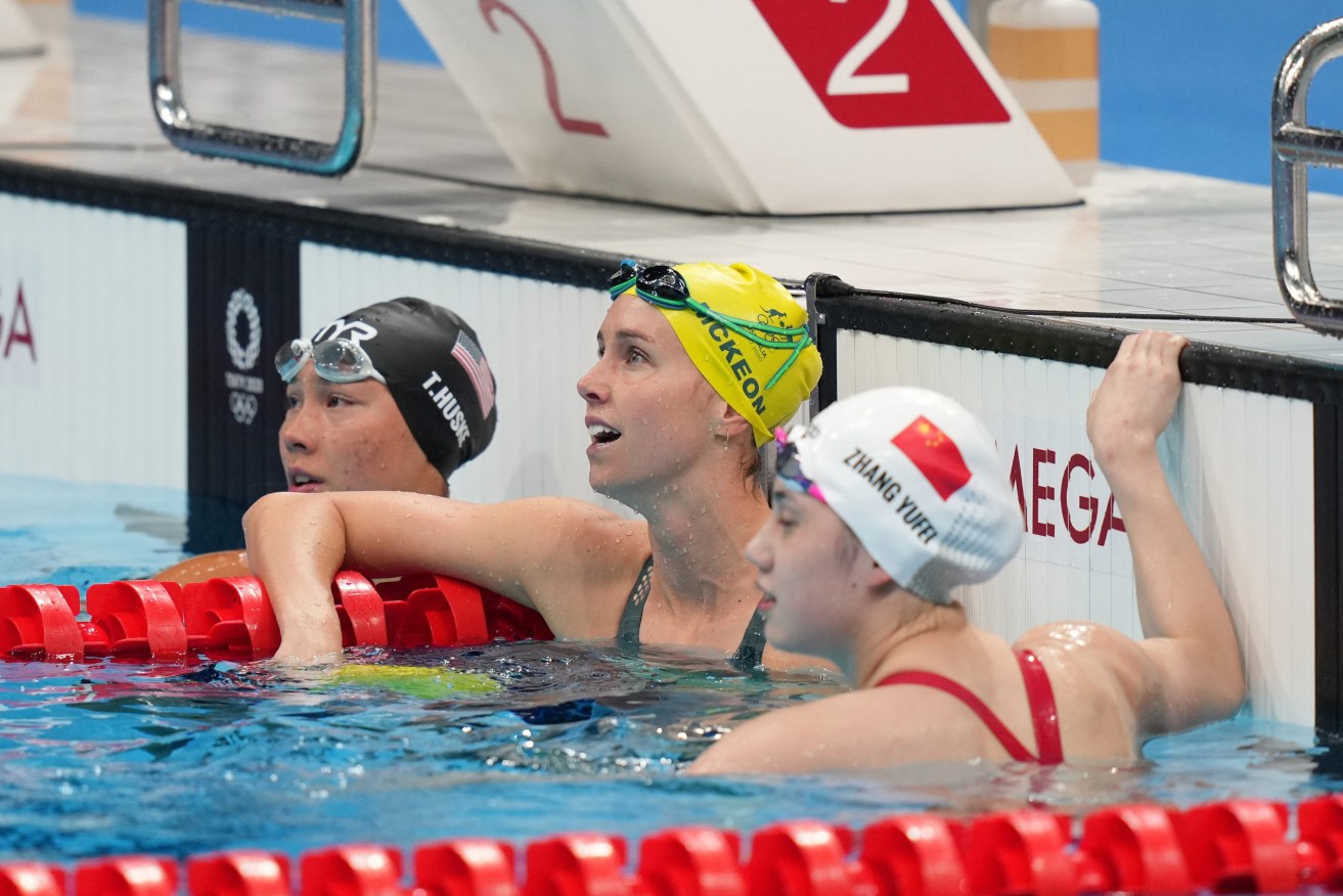 Emma McKeon (right) of Australia reacts following her Bronze medal swim in the Women's 100m Butterfly Final at the Tokyo Aquatics Centre. (AAP Image/Joe Giddens) 