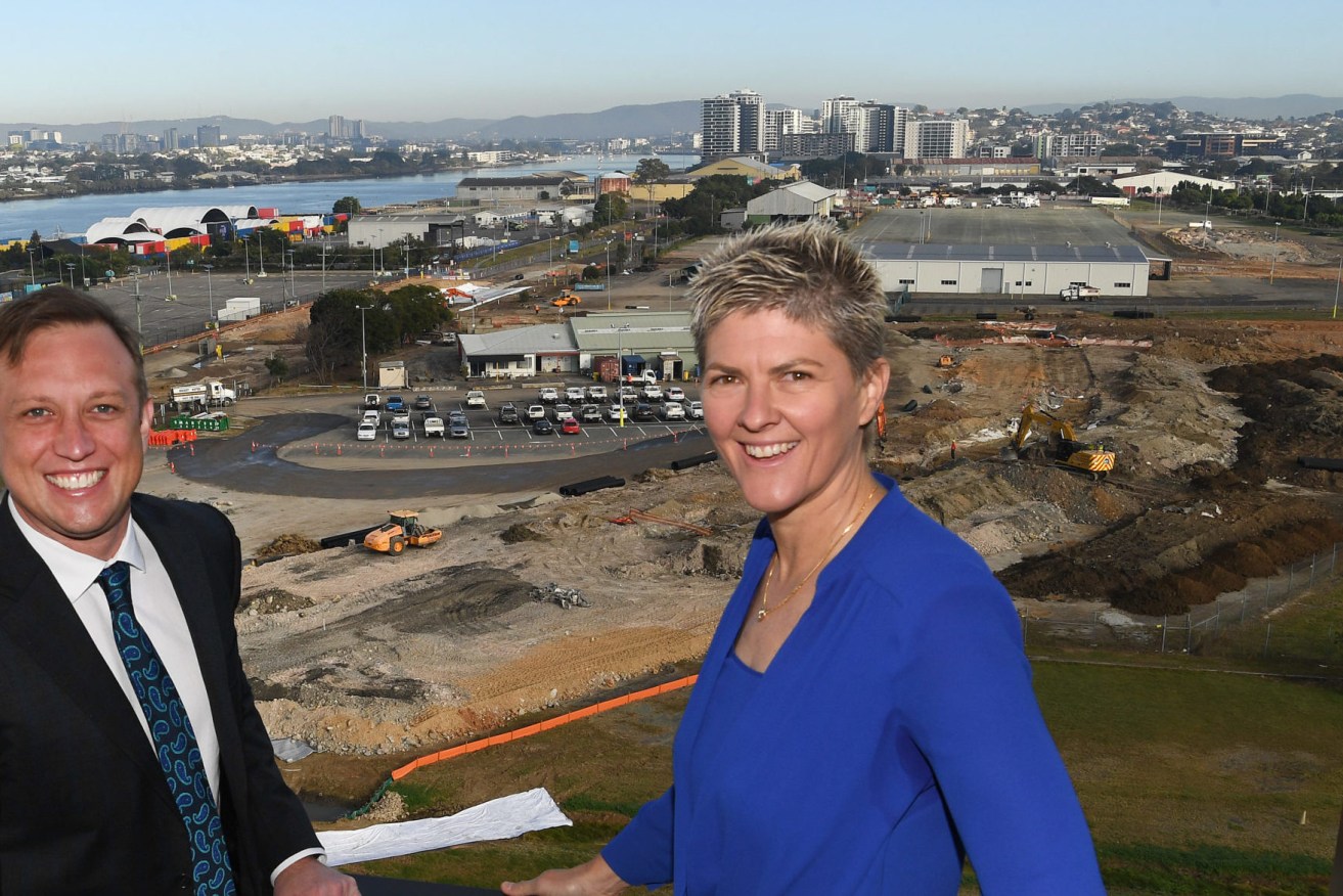 Queensland Deputy Premier Steven Miles (left) and Australian Olympic Gold Medalist Natalie Cook (right) are seen looking over the site of the future Olympic athlete’s village at Northshore Hamilton. (AAP Image/Darren England) 