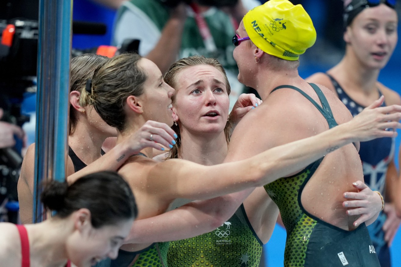 Madison Wilson, Emma McKeon and Ariarne Titmus embrace Leah Neale of Australia (right) after she swam the final leg in the women’s 4x200m freestyle relay final. (AAP Image/Joe Giddens) 
