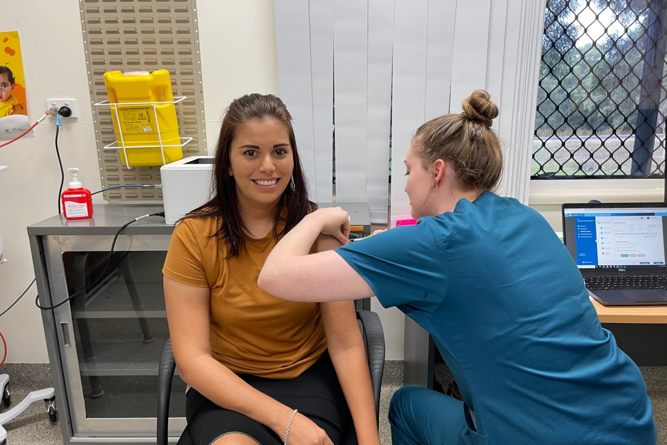 Cooktown Multipurpose Health Service Business Support Officer Desiree Gibson is vaccinated by immunisation nurse Sophie Jones. (Supplied)