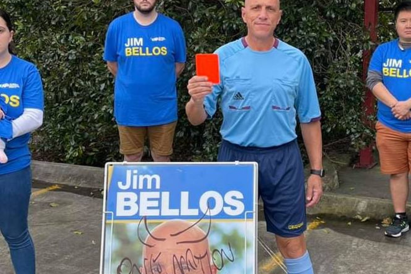 Liberal National Party candidate Jim Bellos (front holding red card) did not respond to a recent survey on Voluntary Assisted Dying. (Facebook)