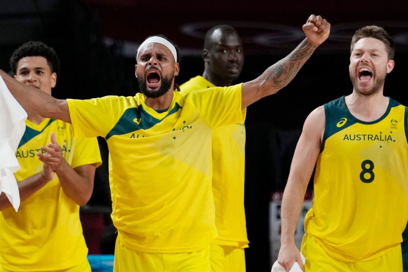 Australia's Patty Mills, left, and Matthew Dellavedova (8) celebrate a score against Argentina during a men's basketball quarterfinal round game. (AP Photo/Eric Gay)