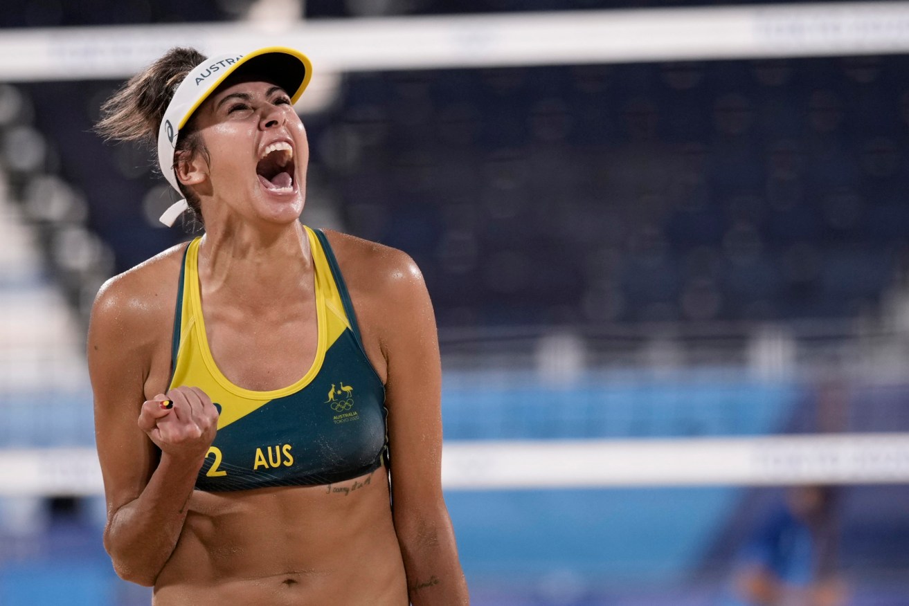 Taliqua Clancy, of Australia, celebrates winning a women's beach volleyball quarterfinal match against Canada. (AP Photo/Felipe Dana)