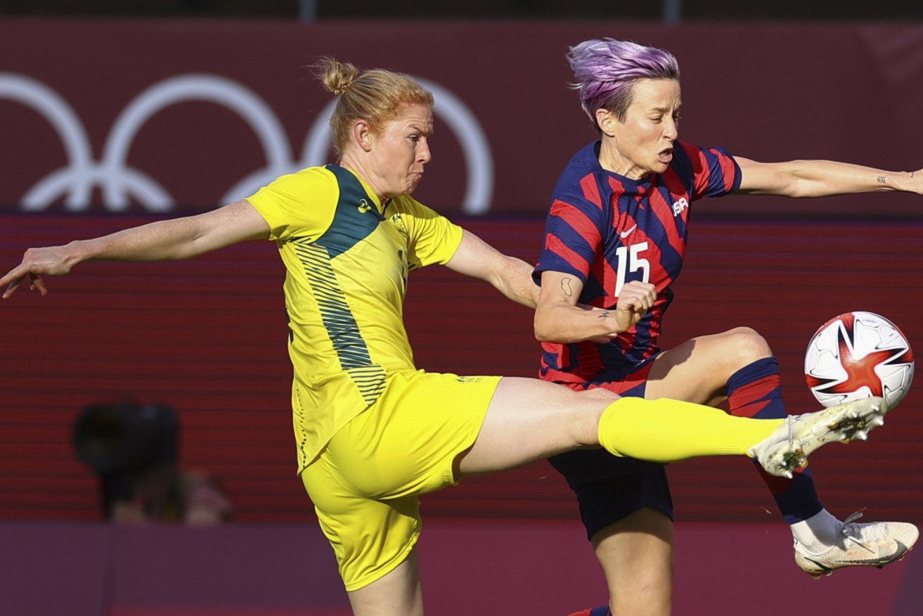 Clare Polkinghorne takes on American superstar Megan Rapinoe during a Matildas match at the Tokyo Olympics. (Reuters)