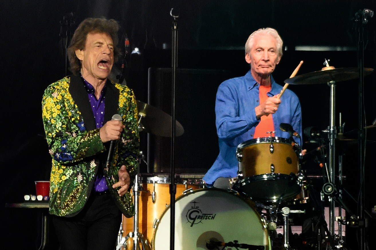 FILE - Rolling Stones drummer Charlie Watts, right, performs behind singer Mick Jagger during their concert at the Rose Bowl, Thursday, Aug. 22, 2019, in Pasadena, Calif. Watts died in London today at age 80. (AP Photo/Chris Pizzello, File)