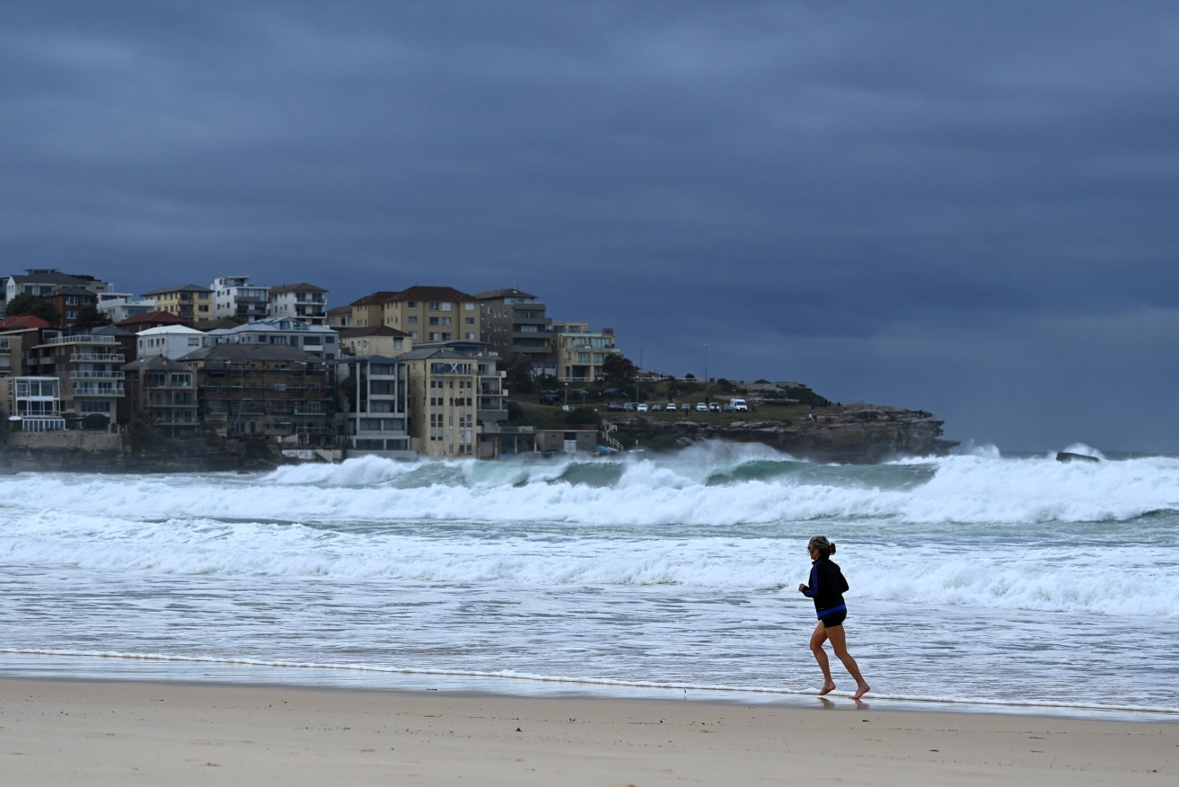 A gloomy scene at Sydney's Bondi Beach on a day when daily case numbers in NSW reached 919. (AAP Image/Bianca De Marchi) 