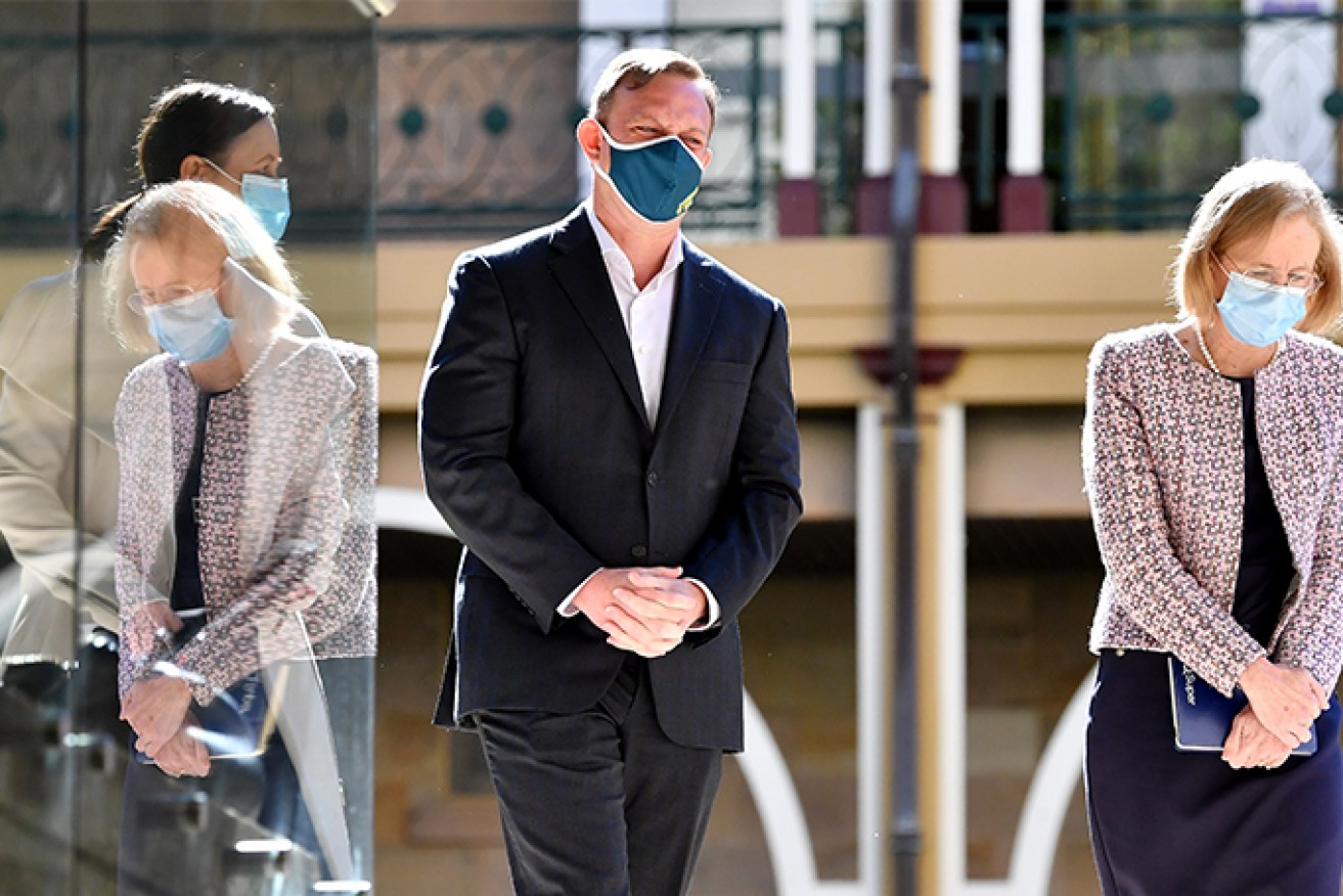 Queensland Deputy Premier Steven Miles (centre) and Queensland Chief Health Officer Dr Jeannette Young (right) are seen leaving a press conference after providing a COVID-19 update in Brisbane. (AAP Image/Darren England)