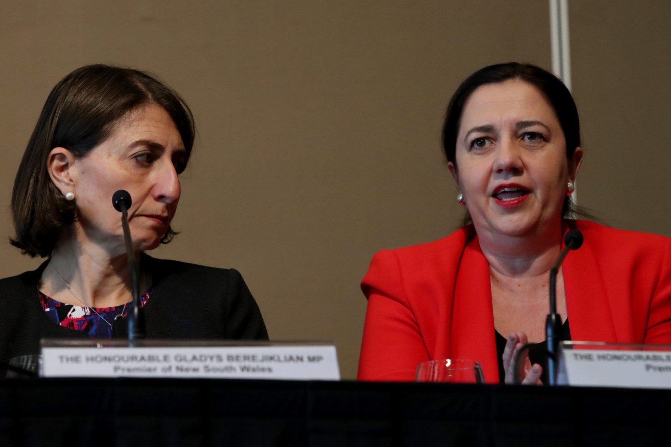 Queensland Premier Annastacia Palaszczuk (right) said her government stands ready to ease restrictions on areas of NSW unaffected by COVID-19. (AAP Image/Kelly Barnes)