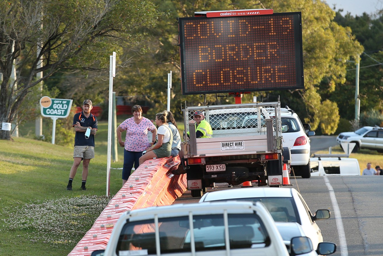 Barriers on roads entering Queensland mean that most people wanting to travel to the state have to catch a flight. (AAP Image/Jono Searle)