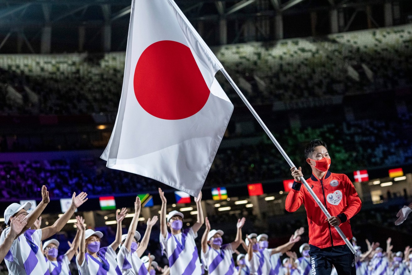 Flag bearer Iwabuchi Koyo of Japan carries the flag into the Olympic Stadium during the closing ceremony of the Tokyo 2020 Paralympic Games on Sunday, Sept. 5. (Thomas Lovelock for OIS via AP)
