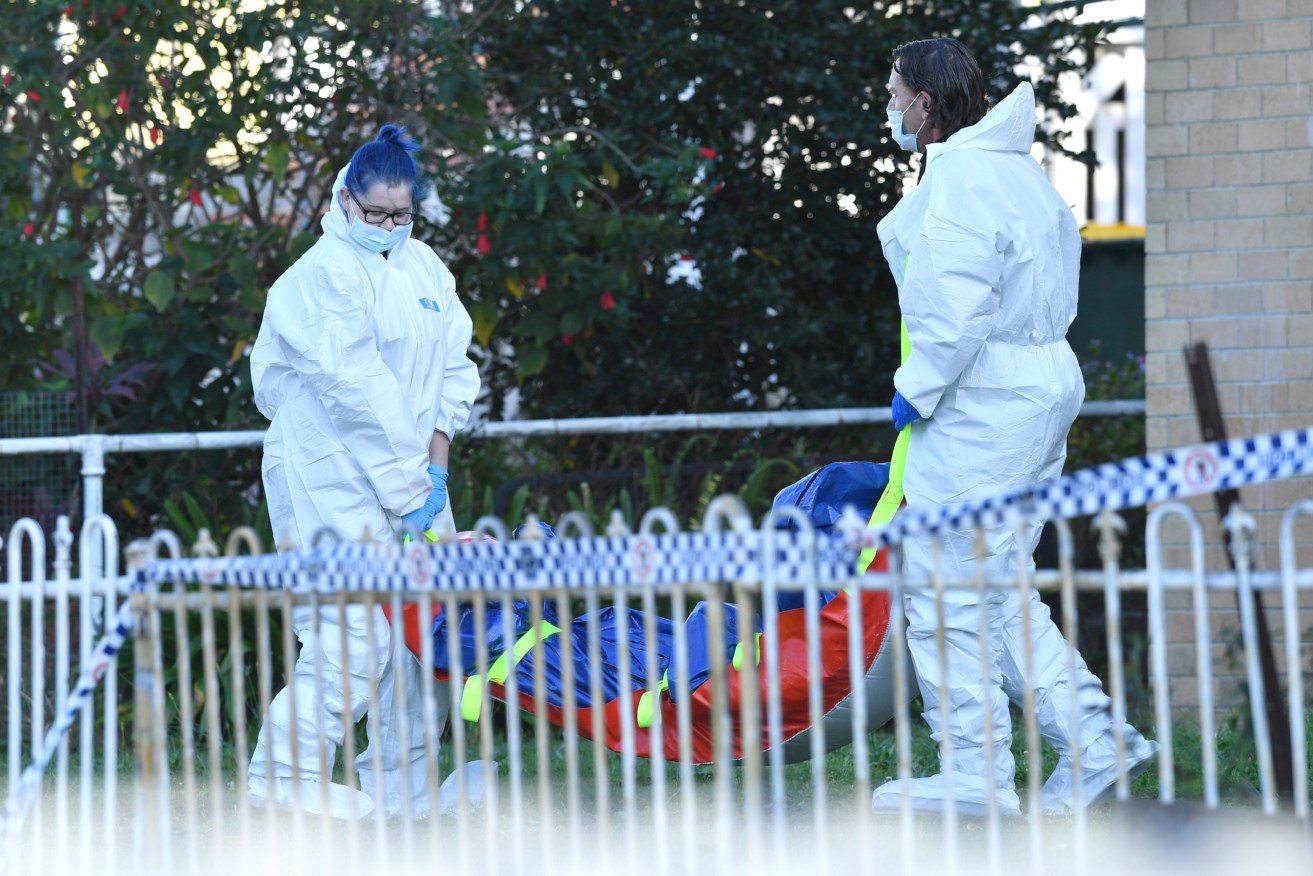 Police are seen removing a body at a crime scene on Wishart Road at Upper Mount Gravatt 
 (AAP Image/Darren England)