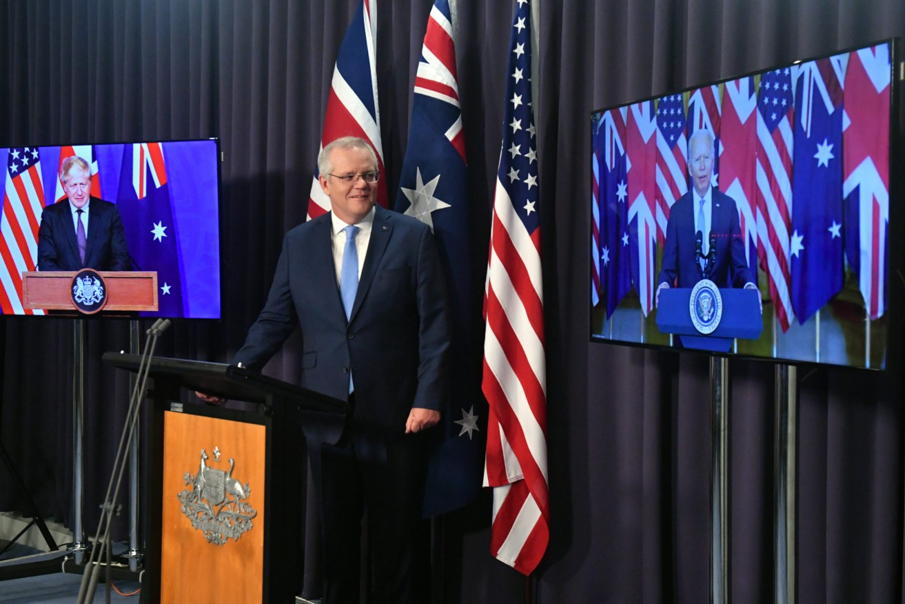 Britain’s Prime Minister Boris Johnson, Australia’s Prime Minister Scott Morrison and US President Joe Biden at a joint press conference. (AAP Image/Mick Tsikas)