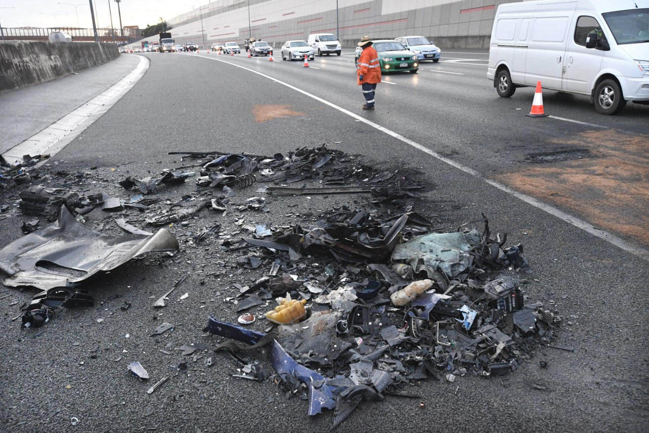 The debris of a fatal car accident are seen on the Ipswich Motorway in Brisbane,. Four people have been killed after two cars collided on the westbound lanes of the Ipswich Motorway at Redbank Plains at 11.15pm on Wednesday night.  (AAP Image/Darren England) 
