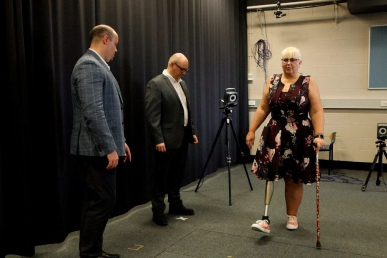Griffith University researchers Dr David Saxby and Professor Laurent Frossard have developed a device to monitor bionic limb stability. Pictured here with Caroline Graydon who has a bone-anchored prosthetic (Image: Supplied)