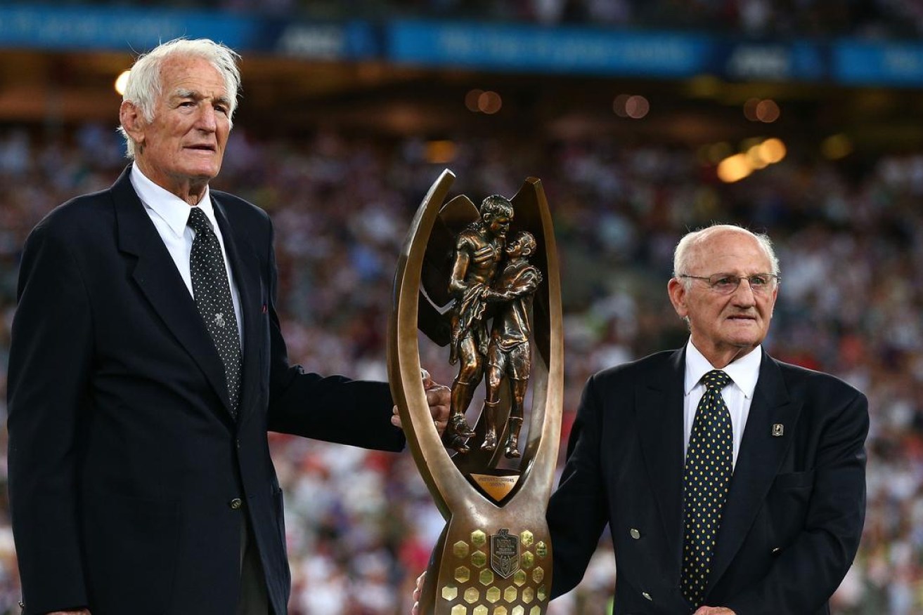 Norm Provan and Arthur Summons hold the NRL trophy, designed on a photograph of the pair.