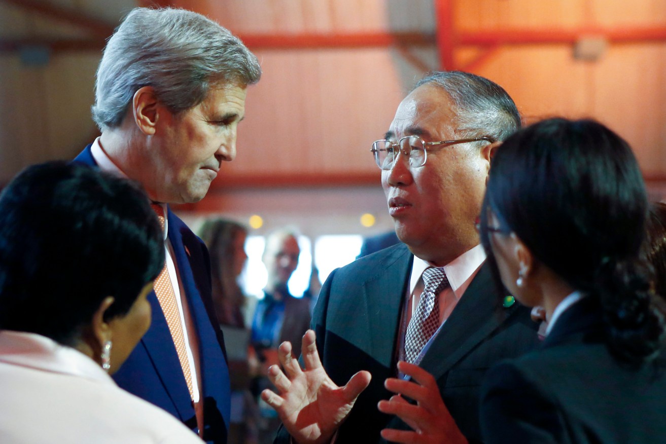Secretary of State John Kerry, left, talks with China's Special Representative on Climate Change Xie Zhenhua. The two emissions super-powers have agreed on a deal on global warming targets. (AP Photo/Francois Mori, File)
