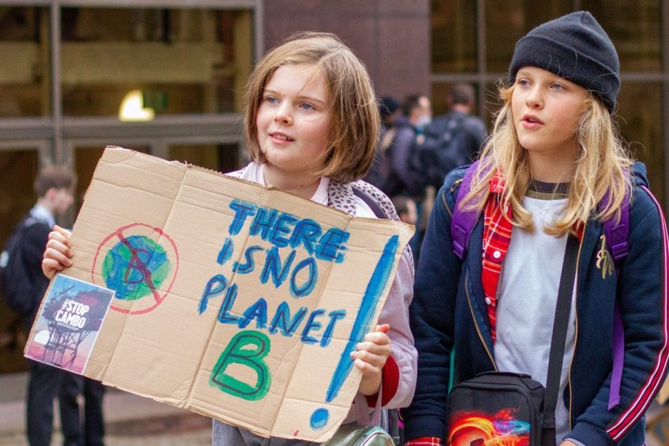 Two children join the march with one holding a placard reading "There is no  planet B" during a rally outside the UN Climate Change Conference in Glasgow. (Photo by Iain McGuinness / SOPA Images/Sipa USA)
