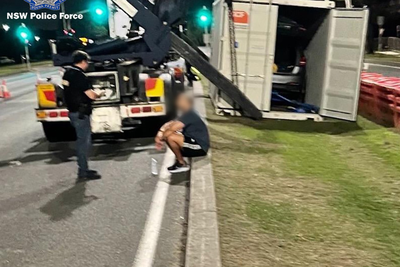  Police have arrested a wanted alleged drug lord after he was located concealed in a vehicle being transported on a truck travelling to Queensland early this morning. (AAP Image/Supplied by NSW Police) 