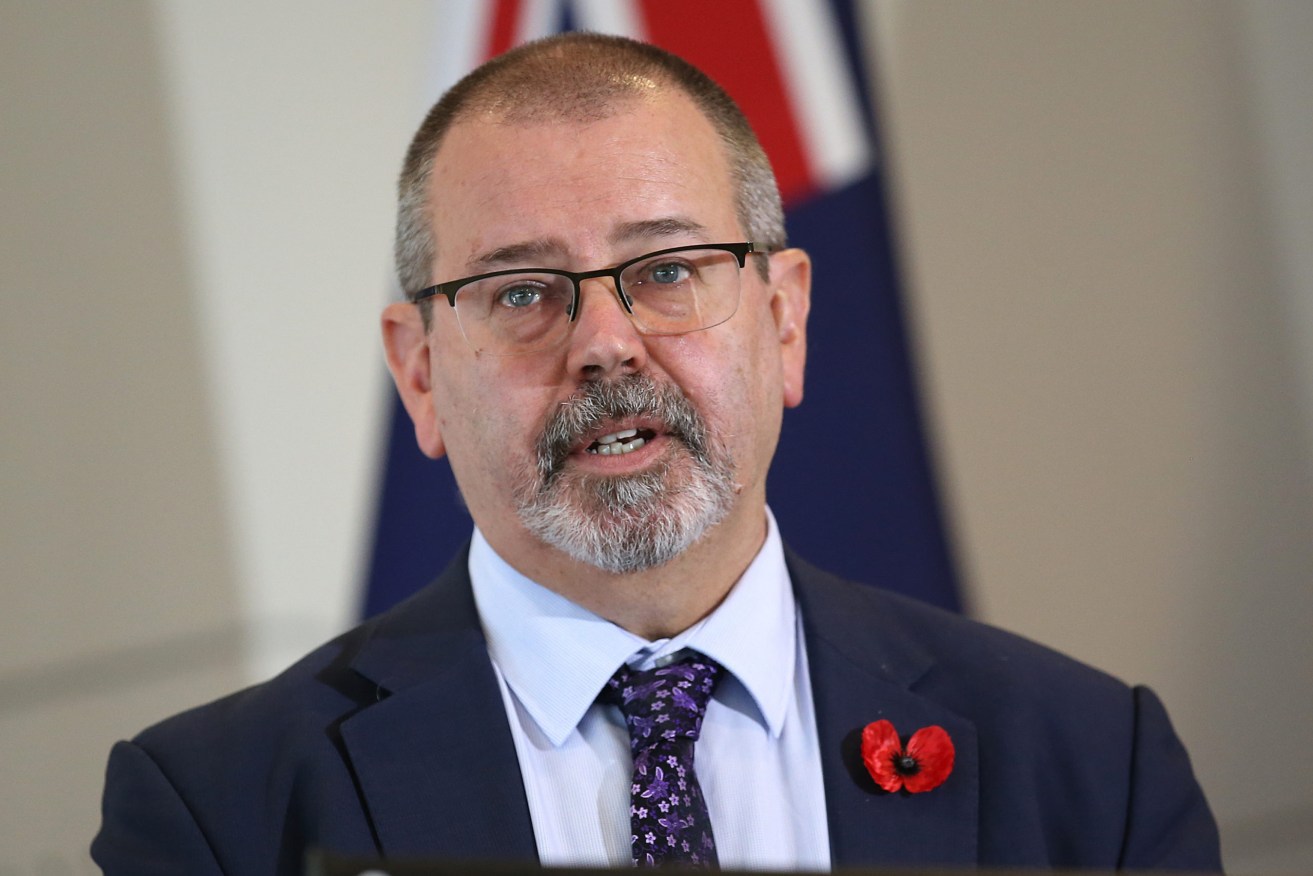 Acting Queensland Chief health officer Peter Aitken says a reduction from two weeks to one week for self-isolation is on the cards.. (AAP Image/Jono Searle) 