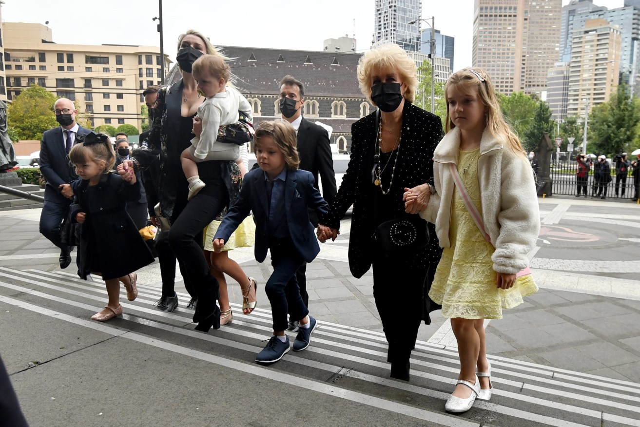 Patti Newton along with daughter Lauren and her husband Matt Welsh and their children arrive at the State Funeral Service for her late husband Bert Newton at St Patrick’s Cathedral in Melbourne(AAP Image/Joel Carrett) 