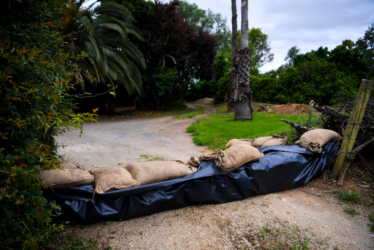 Sandbags are seen outside a house in preparation of potential flooding in the NSW town of Forbes, Monday, November 15, 2021. Thousands of people in the NSW central west have been warned to prepare to evacuate as the Lachlan River floods. (AAP Image/Lukas Coch) 