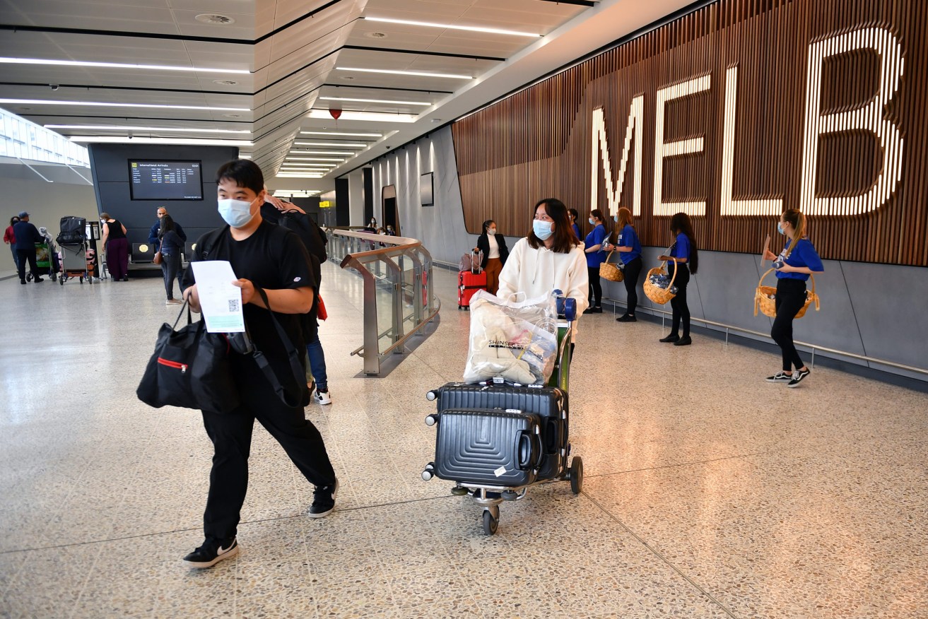 Passengers on a Singapore Airlines flight arrive at Melbourne International Airport. The federal governments set to open the borders to international students and skilled migrants with an announcement on Monday. (AAP Image/Joel Carrett) 
